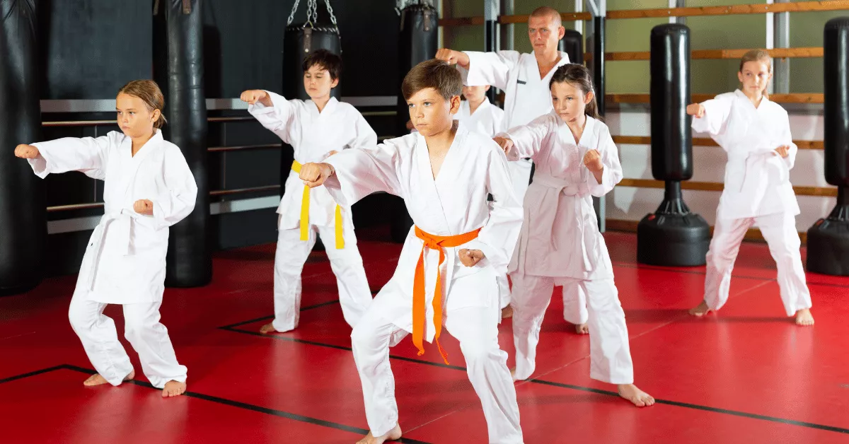 Children practicing punches in a structured martial arts class, showing the discipline side of kids martial arts vs ninja training programs.