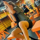 Child climbing a rope during a Mission Grit obstacle course activity designed to build confidence.