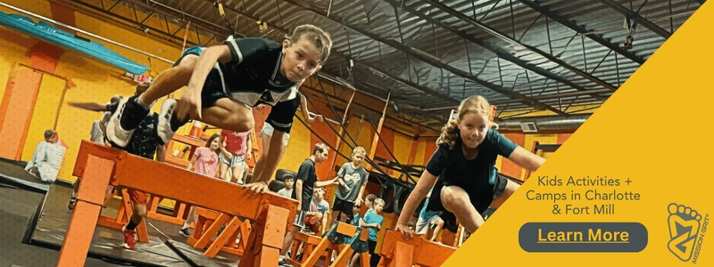 Kids climbing over obstacle course equipment during a Mission Grit leadership and adventure program in Charlotte, NC.