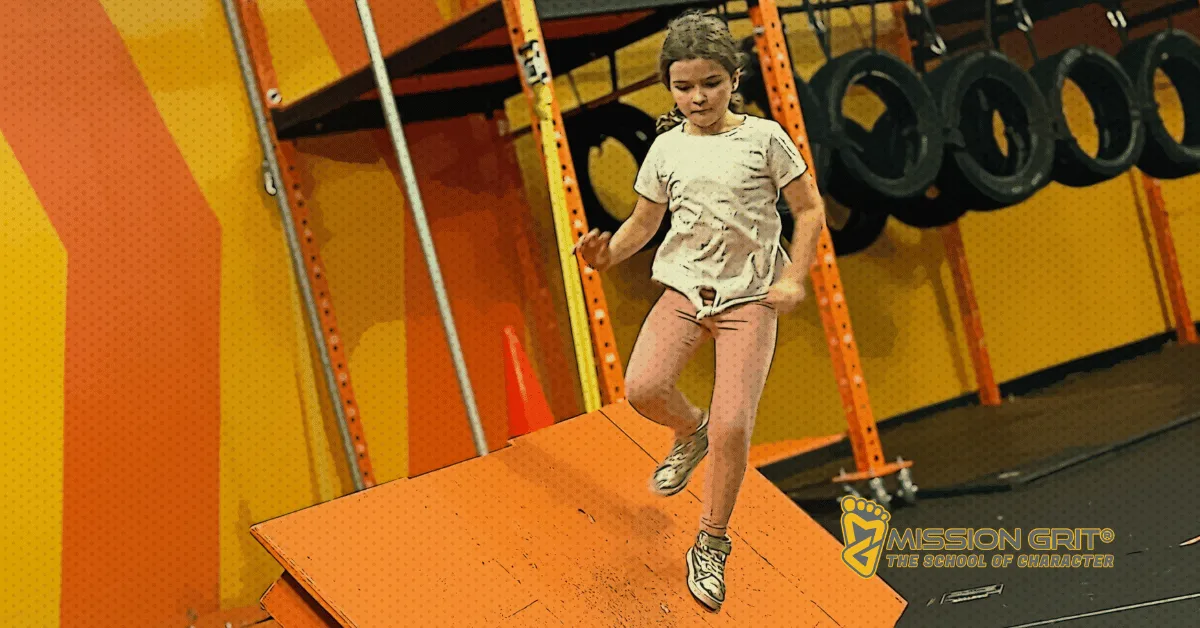 Child balancing on an obstacle during a Mission Grit Xplor program designed to build confidence and resilience.